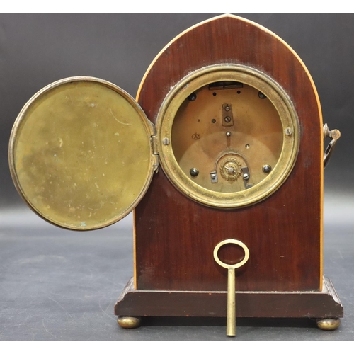 906 - An Edwardian mahogany time piece with inlaid shell motif and stringing, 2 brass carrying handles on ... 