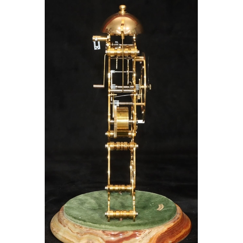 910 - A modern gilt metal striking skeleton clock on round onyx base with dome (Clip to top of pendulum mi... 