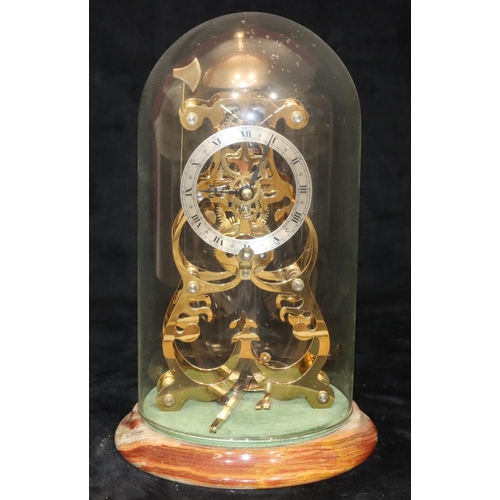 910 - A modern gilt metal striking skeleton clock on round onyx base with dome (Clip to top of pendulum mi... 