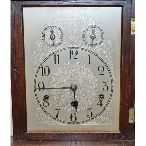 914 - Kienzle, German oak 8-day striking Westminster chime mantel clock with arched silvered dial and Arab... 