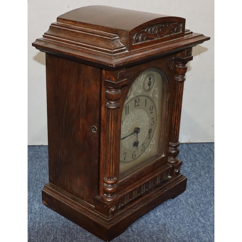 914 - Kienzle, German oak 8-day striking Westminster chime mantel clock with arched silvered dial and Arab... 