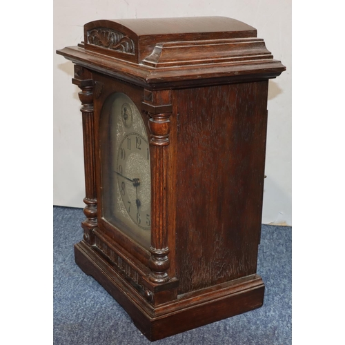 914 - Kienzle, German oak 8-day striking Westminster chime mantel clock with arched silvered dial and Arab... 