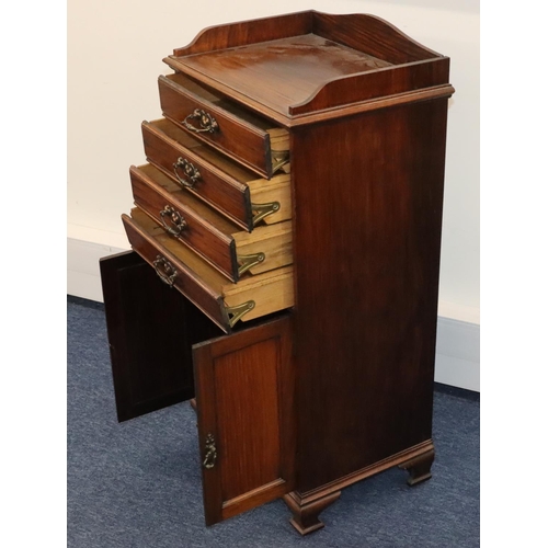 932 - A walnut music cabinet with lit back, 4 drawers with drop fronts above 2 panel doors, on ogee feet, ... 