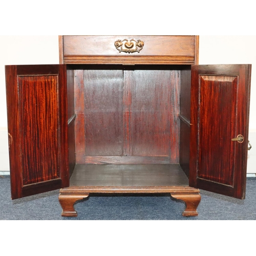 932 - A walnut music cabinet with lit back, 4 drawers with drop fronts above 2 panel doors, on ogee feet, ... 