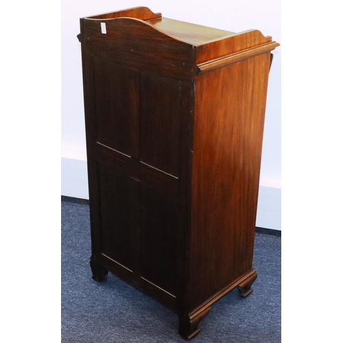 932 - A walnut music cabinet with lit back, 4 drawers with drop fronts above 2 panel doors, on ogee feet, ... 