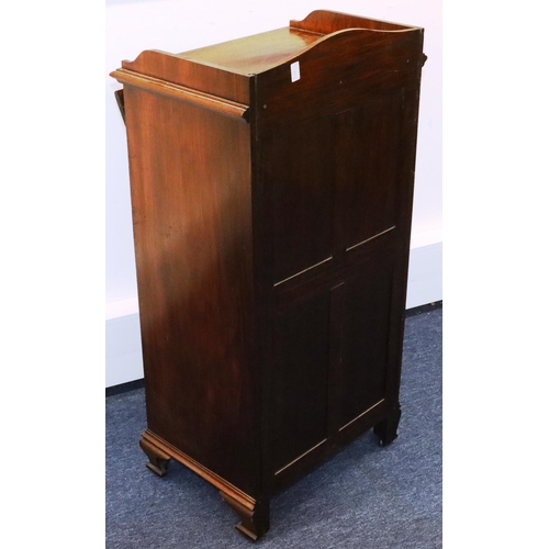 932 - A walnut music cabinet with lit back, 4 drawers with drop fronts above 2 panel doors, on ogee feet, ... 