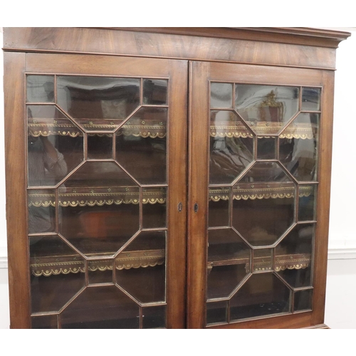 939 - A George III mahogany bookcase with 2 astragal glass doors enclosing leather fronted adjustable shel... 