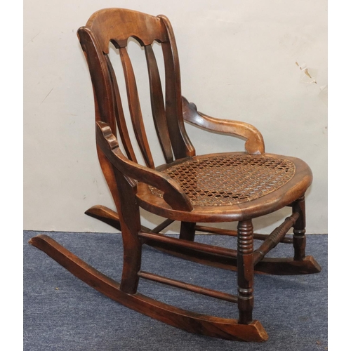 940 - A 19th Century mahogany small rocking nursing chair with cane seat ad splat back