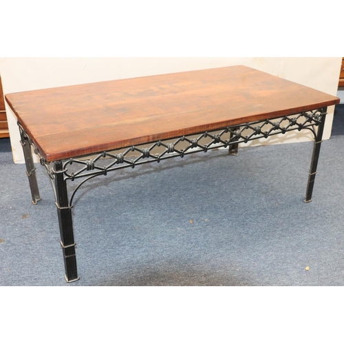 947 - A heavy wrought iron and mahogany topped rectangular shaped coffee table with pierced frieze on squa... 