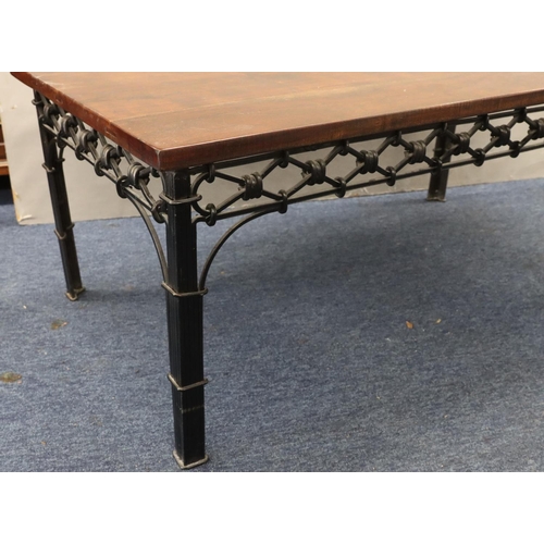 947 - A heavy wrought iron and mahogany topped rectangular shaped coffee table with pierced frieze on squa... 