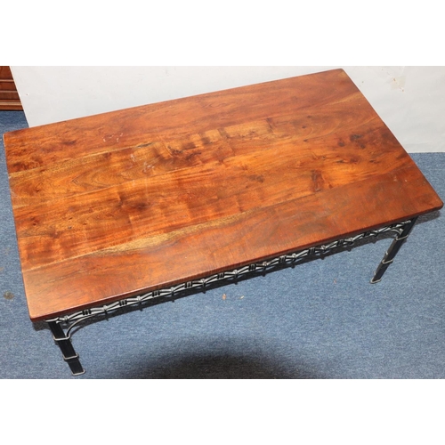 947 - A heavy wrought iron and mahogany topped rectangular shaped coffee table with pierced frieze on squa... 