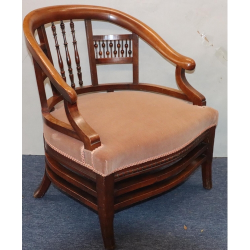 952 - A mahogany low tub nursing chair with spindle back, velvet overstuffed seat, on splayed legs