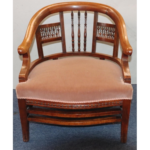 952 - A mahogany low tub nursing chair with spindle back, velvet overstuffed seat, on splayed legs