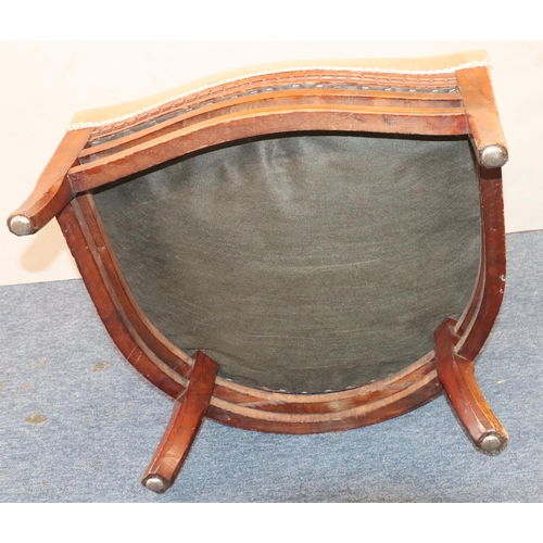 952 - A mahogany low tub nursing chair with spindle back, velvet overstuffed seat, on splayed legs