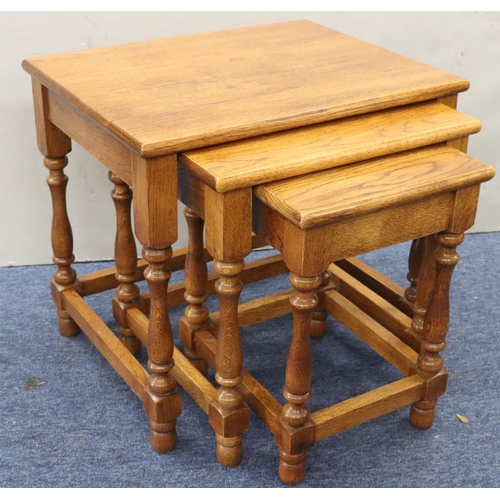 953 - A nest of 3 oak rectangular shaped coffee tables on round turned legs, largest 51cm wide