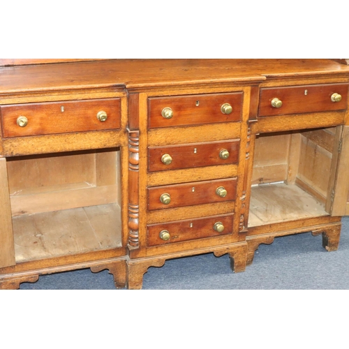 954 - A George III oak and mahogany breakfront Welsh dresser with shelfed back, 4 graduated centre drawers... 