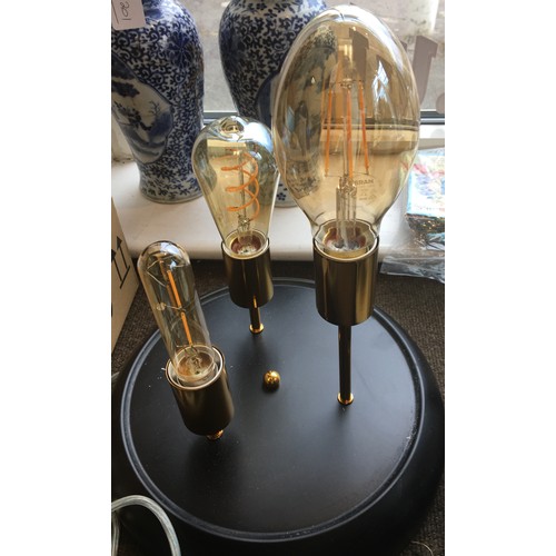 8114 - A modern lamp with 3 reproduction vintage style bulbs and glass dome on circular black metallic base... 