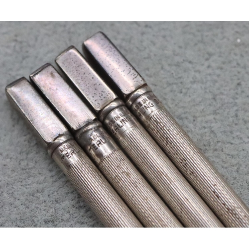 359 - A set of 4 sterling silver Bridge propelling pencils with engine turned decoration in fitted red lea... 