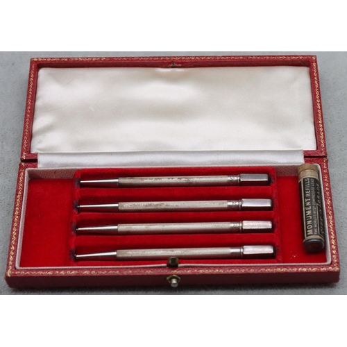 359 - A set of 4 sterling silver Bridge propelling pencils with engine turned decoration in fitted red lea... 