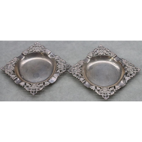 365 - A pair of sterling silver square ash trays with pierced and embossed floral and leaf decoration, 4.2... 