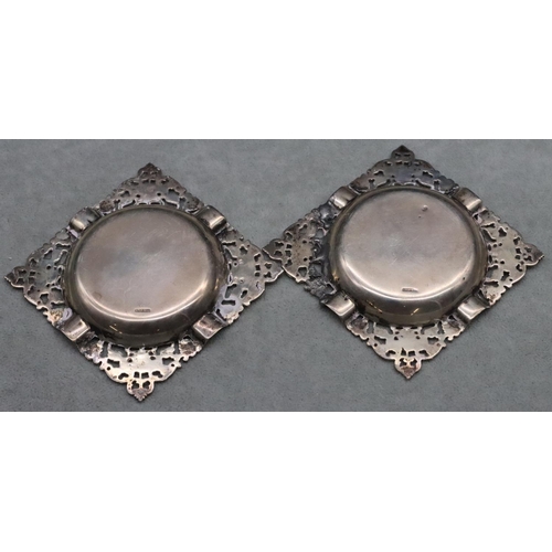 365 - A pair of sterling silver square ash trays with pierced and embossed floral and leaf decoration, 4.2... 