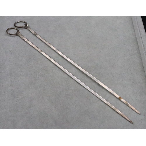 366 - A pair of silver coloured metal meat skewers with ringed ends, 0.91oz