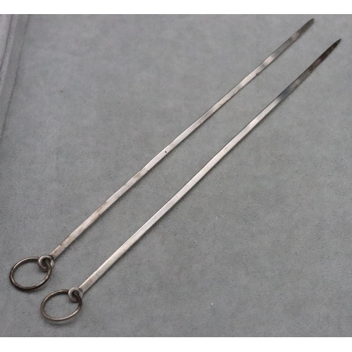 366 - A pair of silver coloured metal meat skewers with ringed ends, 0.91oz