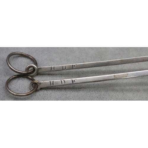 366 - A pair of silver coloured metal meat skewers with ringed ends, 0.91oz