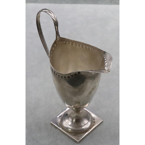 378 - A Victorian silver cream jug with scroll handle on square base, Birmingham 1893, 14.5cm high, 3.3oz