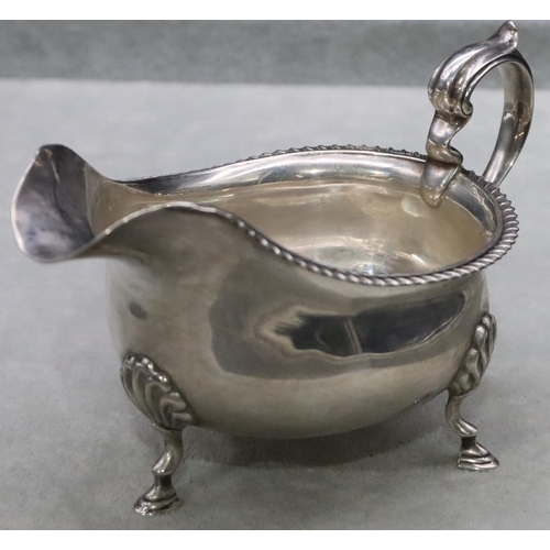 381 - A Birmingham silver sauce boat with gadroon rim, scroll handle on splayed hoof feet, maker Walker & ... 