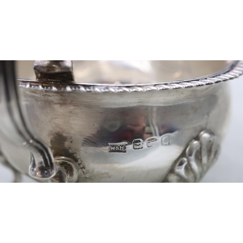 381 - A Birmingham silver sauce boat with gadroon rim, scroll handle on splayed hoof feet, maker Walker & ... 