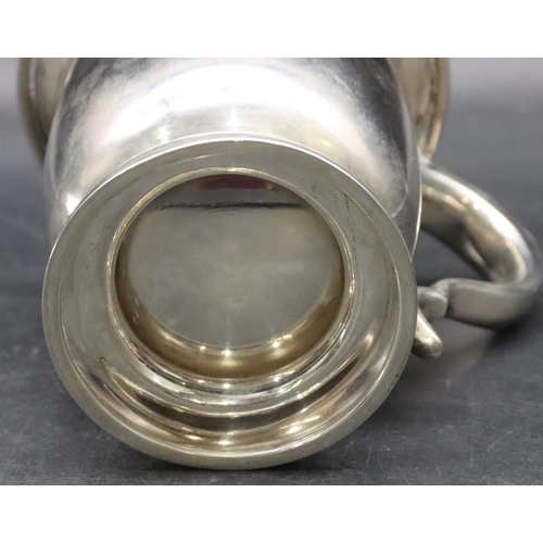 382 - A Birmingham plain silver trumpet shaped tankard with scroll handle on sweeping foot, 13cm high, 8.3... 