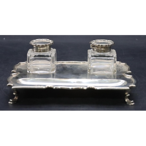 384 - An Edward VII silver rectangular scallop shaped ink stand on splayed hoof feet with a pair of square... 