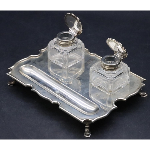 384 - An Edward VII silver rectangular scallop shaped ink stand on splayed hoof feet with a pair of square... 