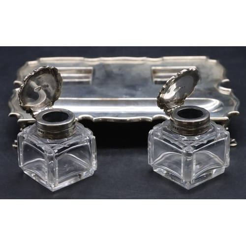 384 - An Edward VII silver rectangular scallop shaped ink stand on splayed hoof feet with a pair of square... 