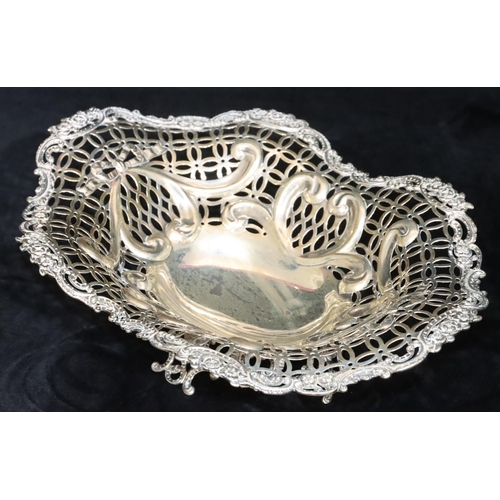 388 - A Victorian silver oval basket with scallop shape and pierced floral, leaf and scroll rim, splayed b... 