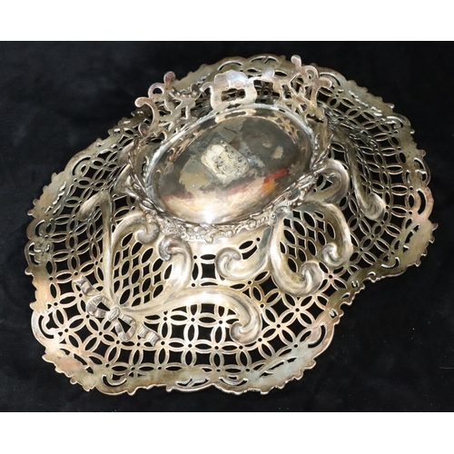 388 - A Victorian silver oval basket with scallop shape and pierced floral, leaf and scroll rim, splayed b... 