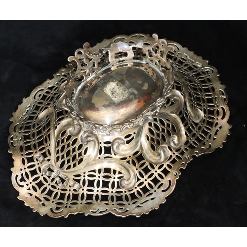 388 - A Victorian silver oval basket with scallop shape and pierced floral, leaf and scroll rim, splayed b... 