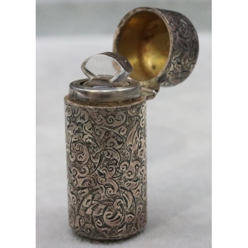 391 - A Victorian silver Sampson Mordan cylindrical scent bottle with allover chased decoration and hinged... 