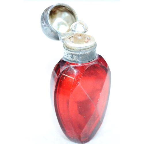 392 - A ruby glass scent bottle with Birmingham silver neck and hinged lid (lid dented) enclosing inner st... 