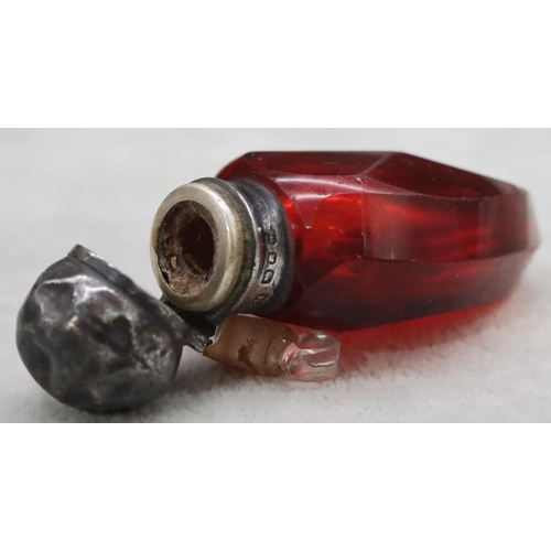 392 - A ruby glass scent bottle with Birmingham silver neck and hinged lid (lid dented) enclosing inner st... 