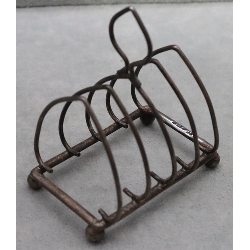 393 - A Birmingham silver small 5-bar toast rack with centre carrying handle on ball feet, maker William H... 