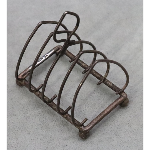 393 - A Birmingham silver small 5-bar toast rack with centre carrying handle on ball feet, maker William H... 