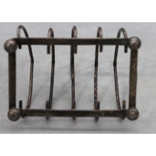 393 - A Birmingham silver small 5-bar toast rack with centre carrying handle on ball feet, maker William H... 