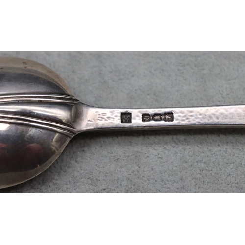 394 - An Edward VII Arts & Crafts presentation rat tail spoon with hammered handle depicting floral motif,... 