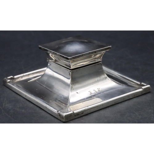 414 - A Birmingham silver square inkwell with hinged lid enclosing glass inkwell, on weighted splayed base... 