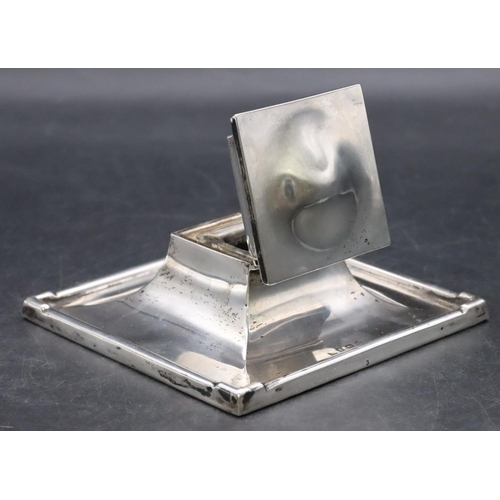 414 - A Birmingham silver square inkwell with hinged lid enclosing glass inkwell, on weighted splayed base... 