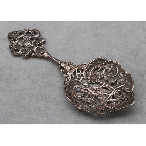 423 - A Victorian London William Comyns  pierced spoon with allover raised figure, cupid and scroll decora... 