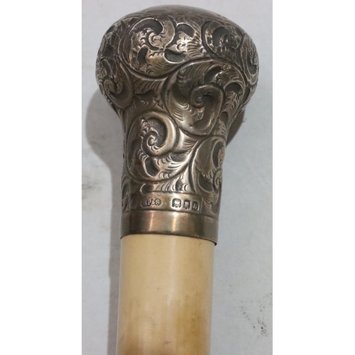 435 - A London silver mounted knob walking cane with embossed leaf and scroll decoration, 92cm high