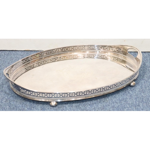 441 - A silver plated oval 2-handled tray with pierced gallery with engraved centre on bun feet, 56.5cm wi... 